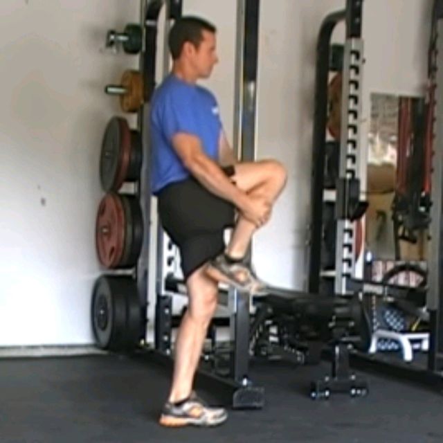 Standing Knee Hugs by Niks M Exercise Howto Skimble